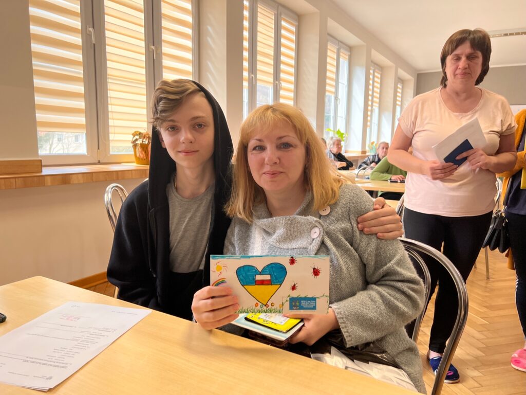 Mother & Teenage Son With Gift Envelope